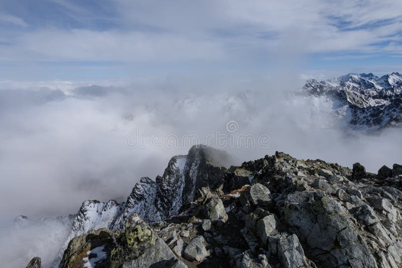 Mountain tops in autumn covered in mist or clouds