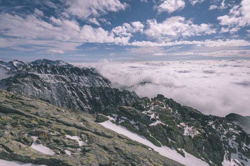 Mountain tops in winter covered in snow - vintage retro look