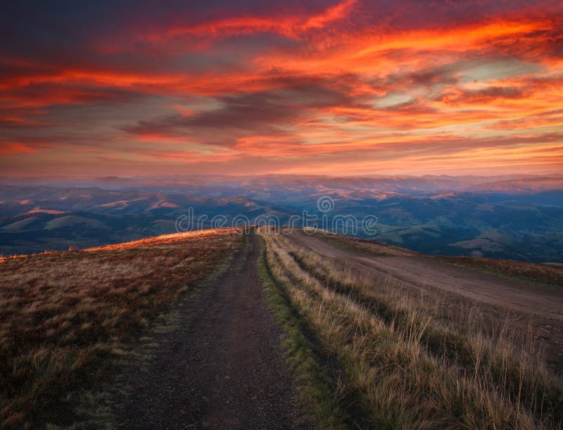 Mountain trail, hiking road on sunset sky background, travel and toursm in the wild nature