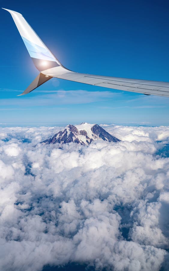 Mountain view on mount rainer out of an airplane above the clouds. vertical shot royalty free stock image