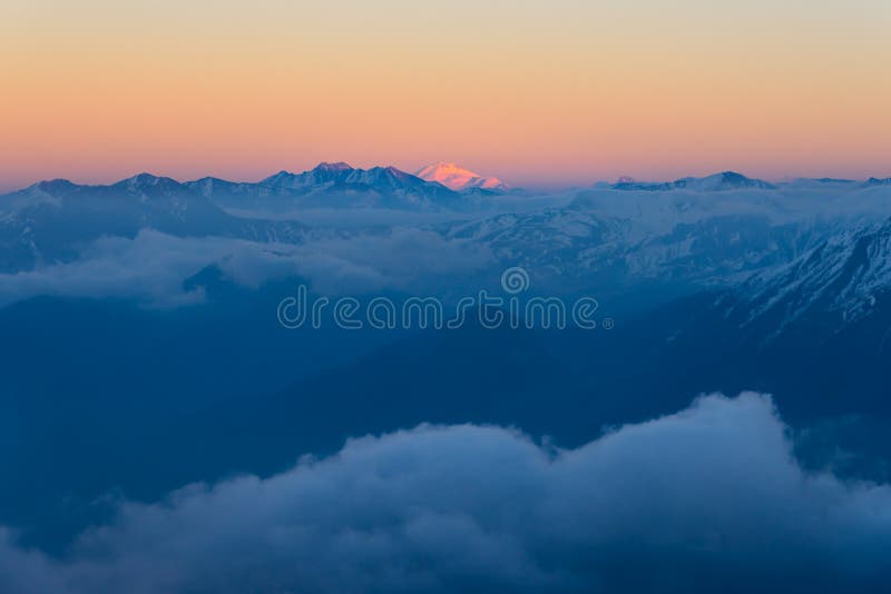 Mountain View at Sunset. Mount Elbrus is Visible on the Horizon Stock