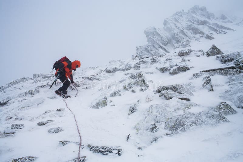 Teamwork in Alpinism. Mountaineering. Traverse of Mountain. Stock Photo
