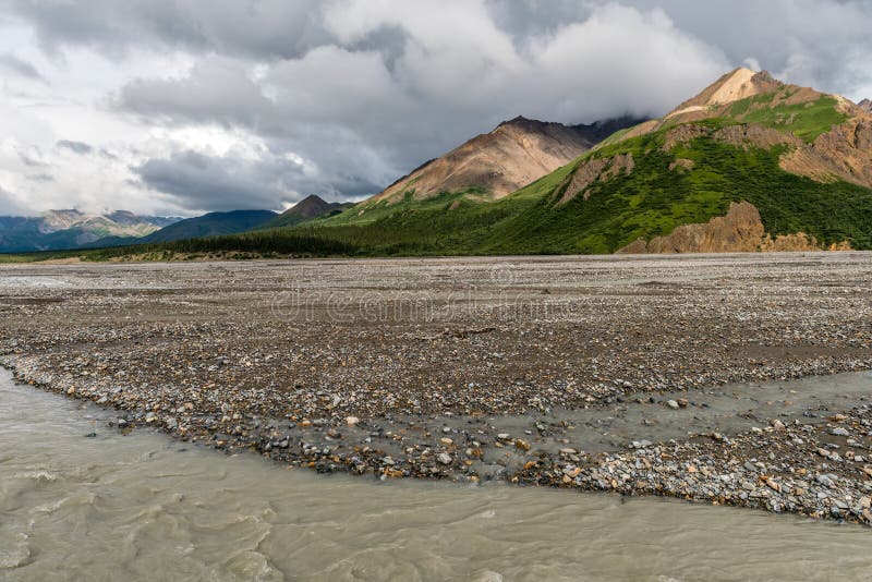 Mountains Tower Over a Gravel Flat in Alaska`s Denali National Park royalty free stock photo Mountains Tower Over a Gravel Flat in Alaska`s Denali National Park royalty free stock photo