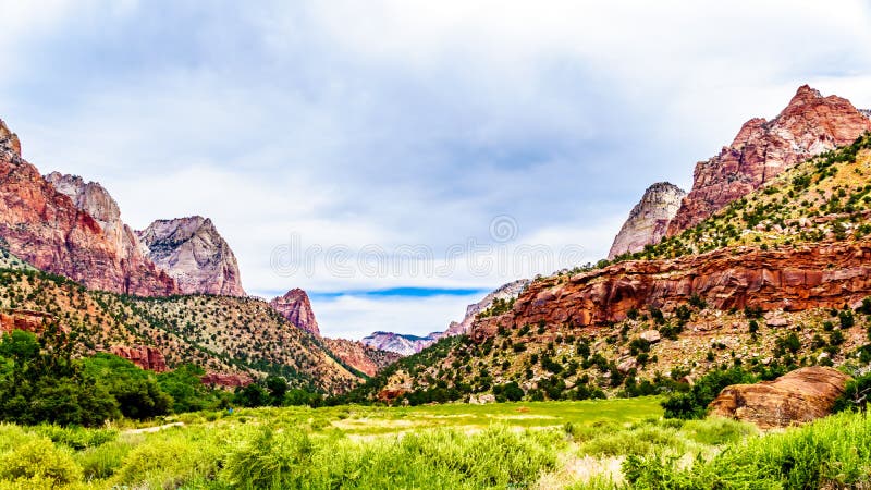 Mountains at both sides of the Pa`rus Trail which follows along and over the meandering Virgin River in Zion National Park in Utah, USA. Mountains at both sides of the Pa`rus Trail which follows along and over the meandering Virgin River in Zion National Park in Utah, USA