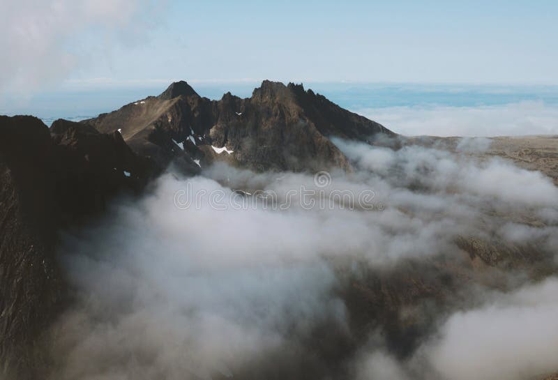 Mountains and clouds landscape in Norway summer travel wilderness nature. Scenic aerial view explore Senja island stock photo Mountains and clouds landscape in Norway summer travel wilderness nature. Scenic aerial view explore Senja island stock photo