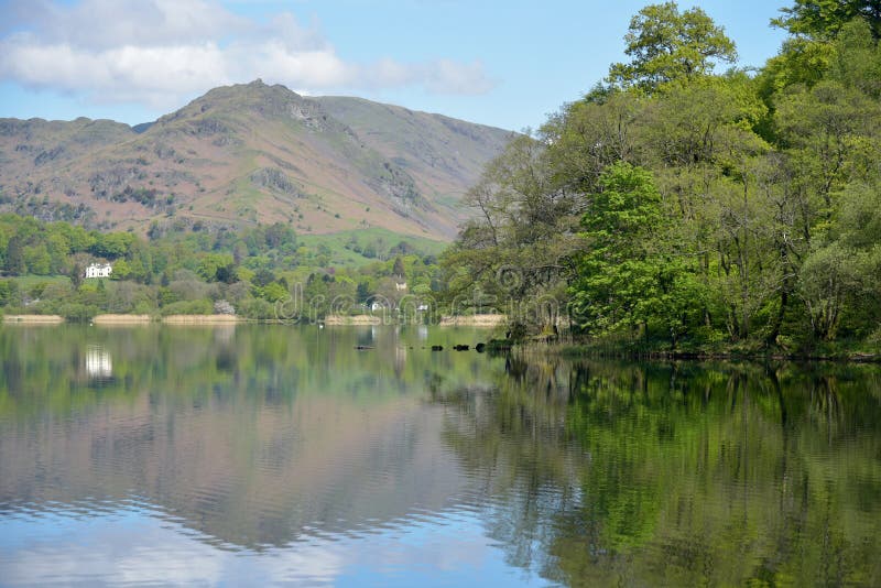 Mountains and Fields Reflected in the Waters of Grasmere Stock Photo