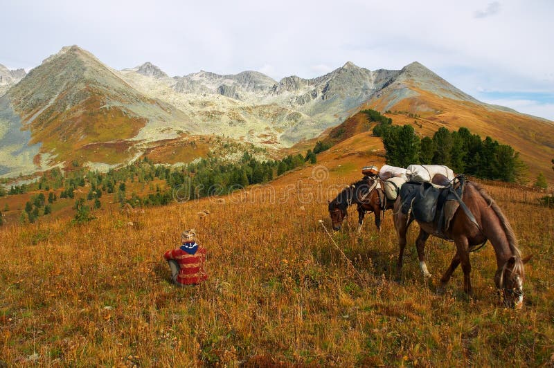 Mountains, girl and two horses.