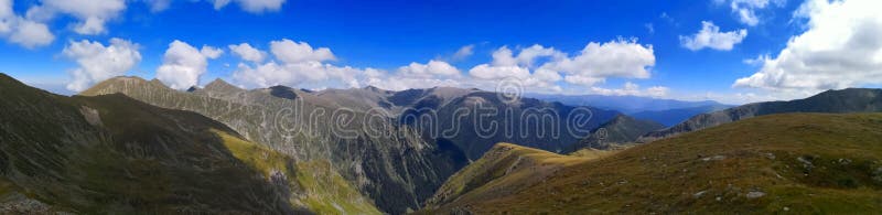 Mountains under blue sky scattered with white fluffy clouds. Amazing landscape panorama in the mountains. Rea trail stock images, royalty-free photos and pictures