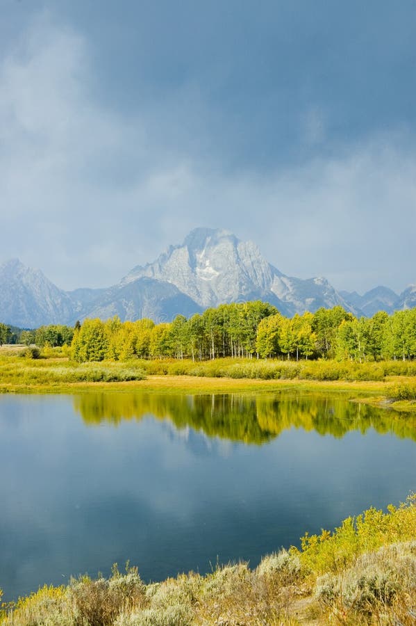 Mountains, sky and fall colors reflected in lake