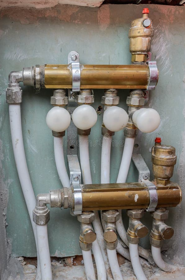 Mounted In The Wall Heating System Of Pipes And Cranes Stock Photo