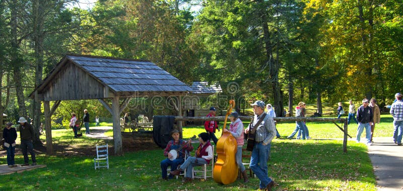 Floyd County, VA – October 6, 2014: Musician playing mountain music at Mabry Mill on the Blue Ridge Parkway on October 6, 2014, Floyd County, Virginia, USA. Floyd County, VA – October 6, 2014: Musician playing mountain music at Mabry Mill on the Blue Ridge Parkway on October 6, 2014, Floyd County, Virginia, USA.