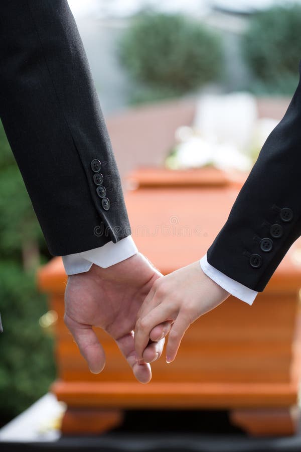 Mourning Woman at Funeral with coffin. Mourning women on funeral with red rose standing at casket or coffin royalty free stock photo Mourning Woman at Funeral with coffin. Mourning women on funeral with red rose standing at casket or coffin royalty free stock photo