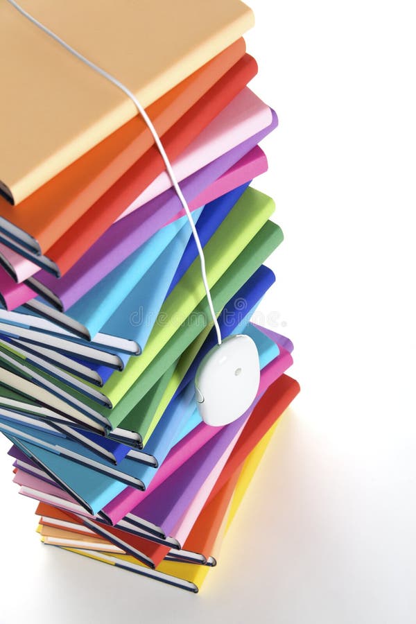 Mouse hanging from top of multi-colored book stack