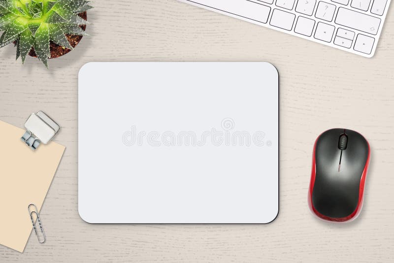 Mouse pad mockup. White mat on the table with props, mouse and keyboard