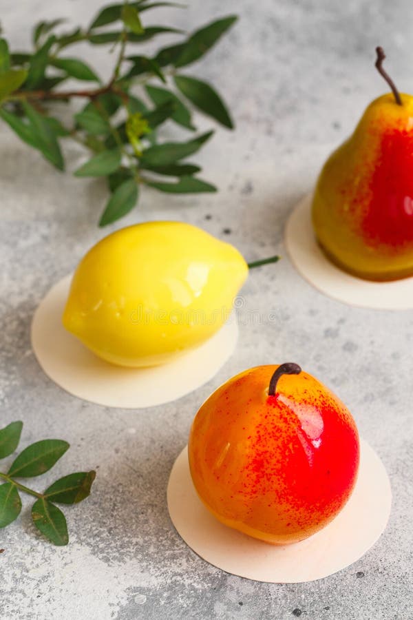 Mousse Dessert in the Shape of a Pear Fruit, Orange Fruit and Cherry
