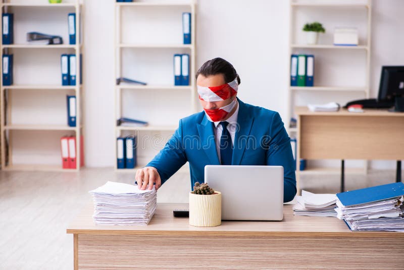 Mouth and Eyes Closed Male Employee Working in the Office Stock Image
