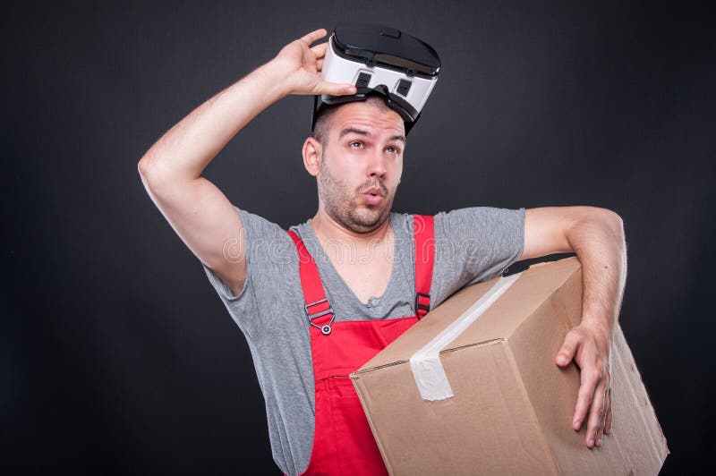 Mover guy holding box putting out vr glasses stock image