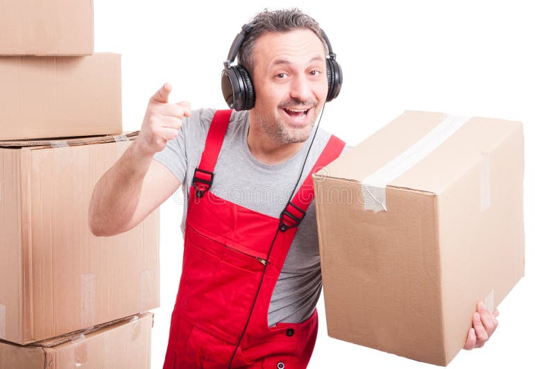 Mover man with headphones on pointing and holding box stock photo