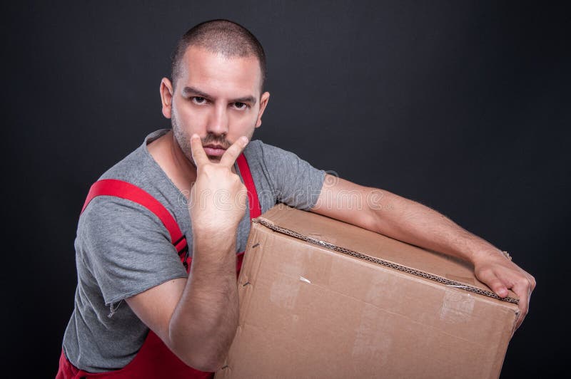 Mover man holding box making look at me gesture stock photo