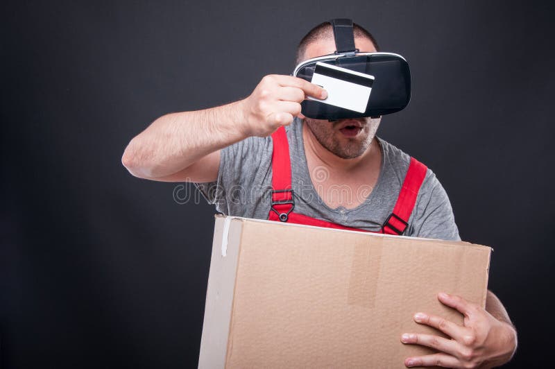Mover wearing vr holding box looking at credit card stock photos