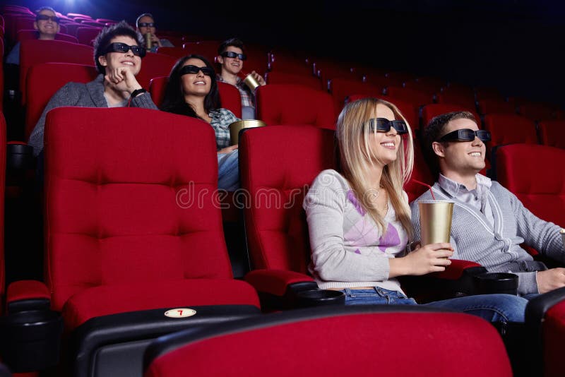 S úsmevom ľudia sledovať filmy v kine.