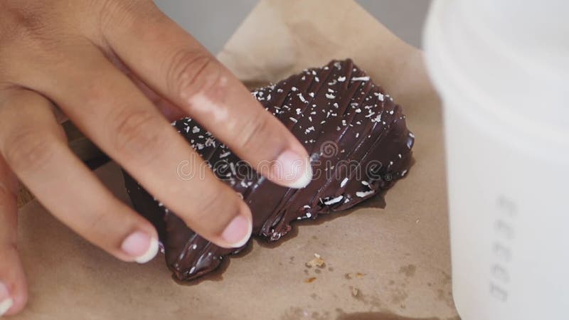 Movimento lento da mão da mulher escolher uma barra de proteína de coco vídeos de arquivo
