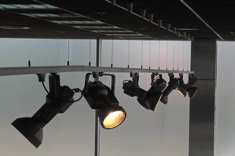 Tracking Spotlights Shines On The Ceiling Rail System Stock Photo