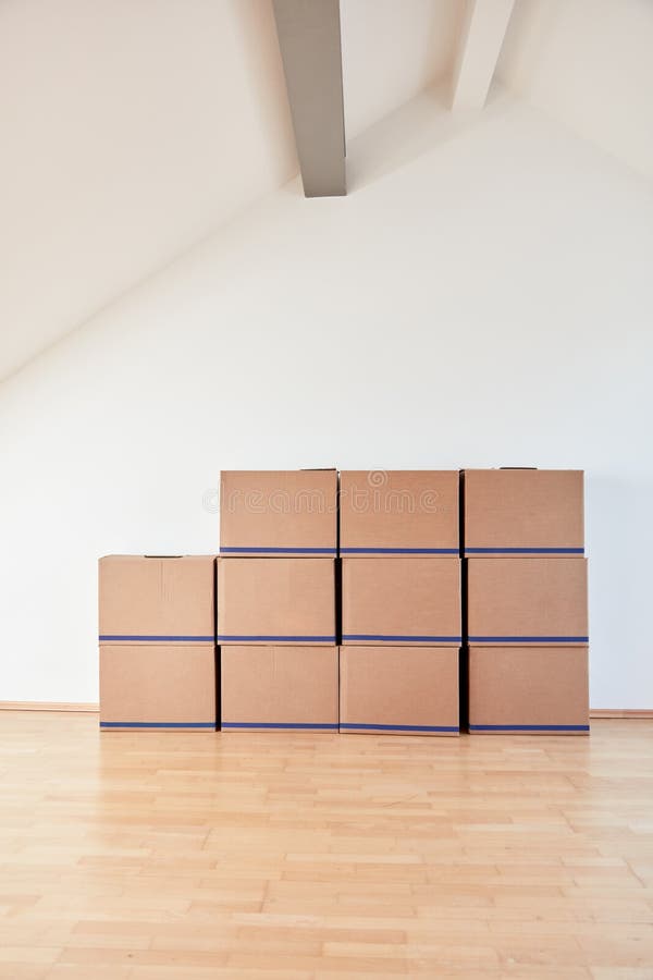 Moving Boxes on Wall in Apartment or Office after Moving in Stock Photo