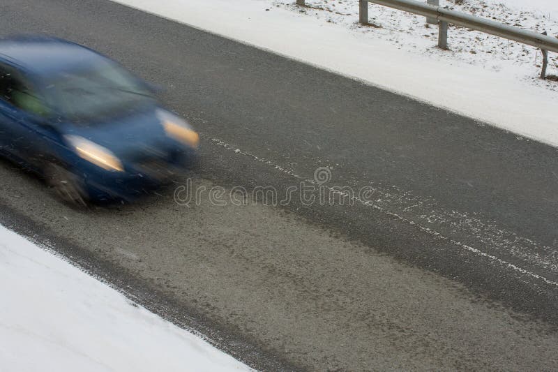 Car with motion blur driving on a road in winter with black ice. Car with motion blur driving on a road in winter with black ice.