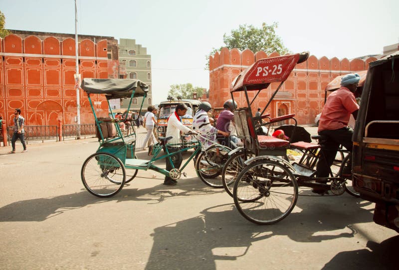 JAIPUR, INDIA: Historical Pink City wall and moving cyclists under blue sky. Jaipur, with population 6,664,000 people, is a capital of Rajasthan. JAIPUR, INDIA: Historical Pink City wall and moving cyclists under blue sky. Jaipur, with population 6,664,000 people, is a capital of Rajasthan