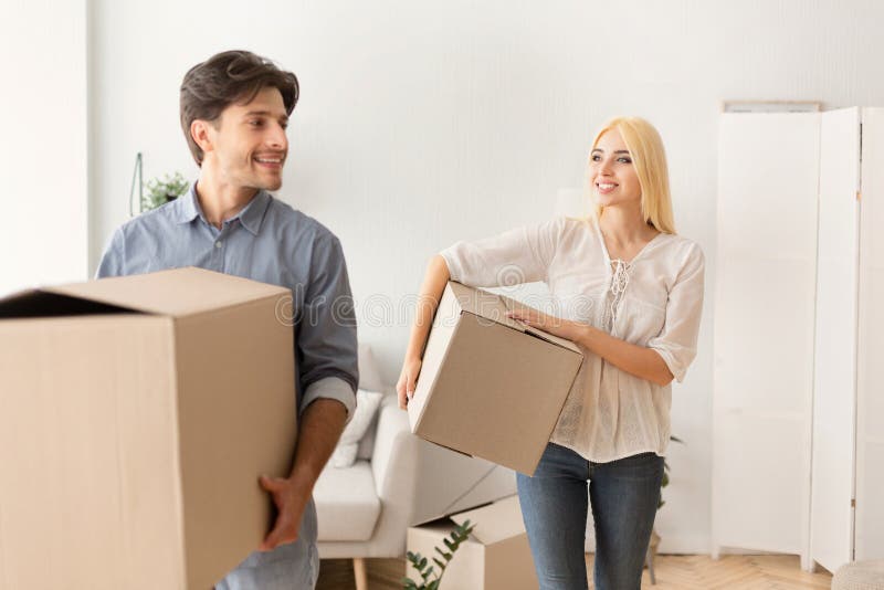 Happy Man And Woman Carrying Moving Boxes Entering New Flat stock image Happy Man And Woman Carrying Moving Boxes Entering New Flat stock image