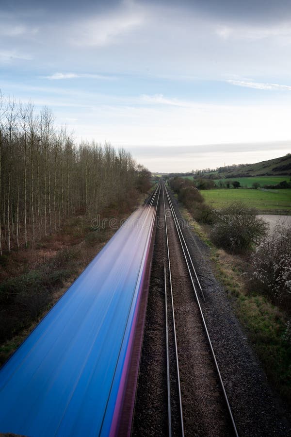 A Moving Train on Straight Tracks in the English Countryside Stock