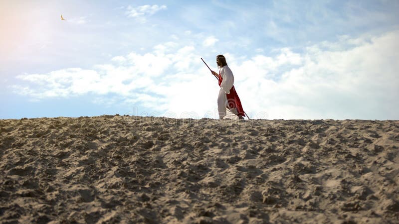 Moses with staff hardly walking in sands, exhausted ascetic fasting to save soul, stock photo. Moses with staff hardly walking in sands, exhausted ascetic fasting to save soul, stock photo