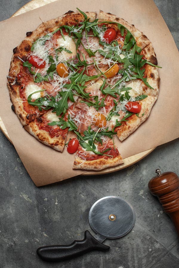 Mozzarella Pizza Top View with Pizza Knife Pepper Mill on Grey Clay Background. Stock Image