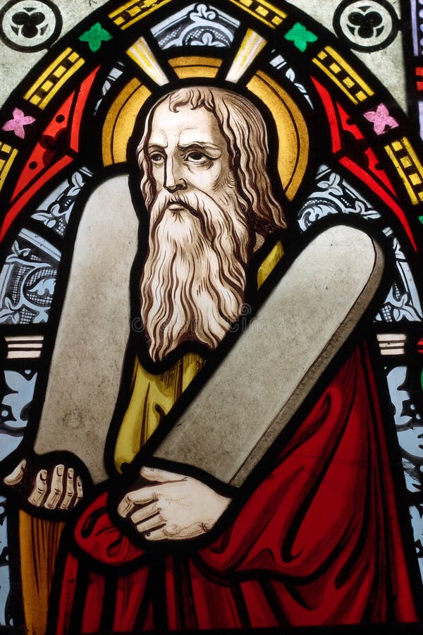 Detail of victorian stained glass church window in Fringford depicting Moses with the tablets of covenant in his arms, interestingly without text, means he is pictured before climbing Mount Sinai. Detail of victorian stained glass church window in Fringford depicting Moses with the tablets of covenant in his arms, interestingly without text, means he is pictured before climbing Mount Sinai