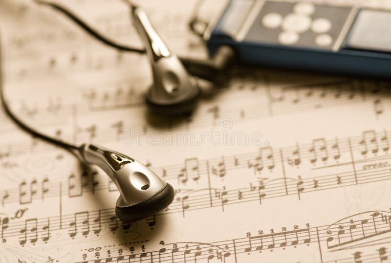 MP3 player and earphones on a music sheet
