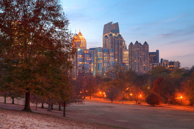 View of the Oak Hill in the Piedmont Park and Midtown Atlanta behind it in autumn twilight, USA. View of the Oak Hill in the Piedmont Park and Midtown Atlanta behind it in autumn twilight, USA