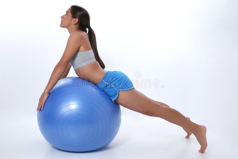 Teen girl in workout clothes stretching over exercise ball. Teen girl in workout clothes stretching over exercise ball.