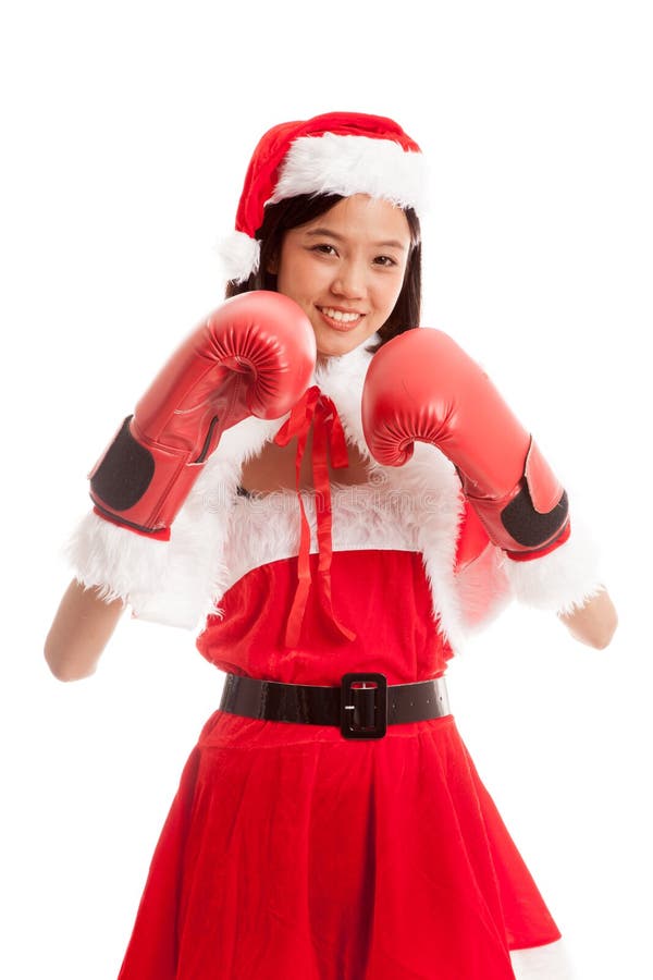 Muchacha asiática de Santa Claus de la Navidad con el guante de boxeo imagenes de archivo Muchacha asiática de Santa Claus de la Navidad con el guante de boxeo imagenes de archivo