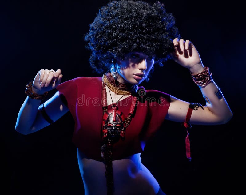 Young beautiful girl with afro on black background. Young beautiful girl with afro on black background