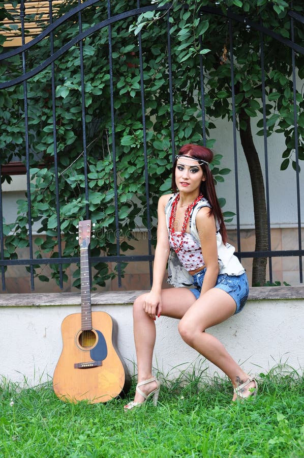 Muchacha bonita con una guitarra al aire libre imagen de archivo libre de regalías Muchacha bonita con una guitarra al aire libre imagen de archivo libre de regalías