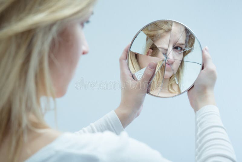 Unhappy pretty girl with complexes and broken mirror. Unhappy pretty girl with complexes and broken mirror