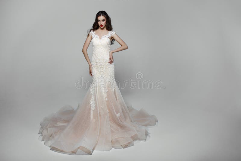 Muchacha de la belleza con el pelo largo rizado en el vestido que se casa blanco con el bordado, aislado en un fondo blanco imágenes de archivo libres de regalías Muchacha de la belleza con el pelo largo rizado en el vestido que se casa blanco con el bordado, aislado en un fondo blanco imágenes de archivo libres de regalías