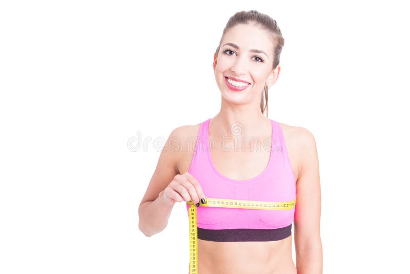 Muchacha en el gimnasio que mide su línea de busto foto de archivo Muchacha en el gimnasio que mide su línea de busto foto de archivo