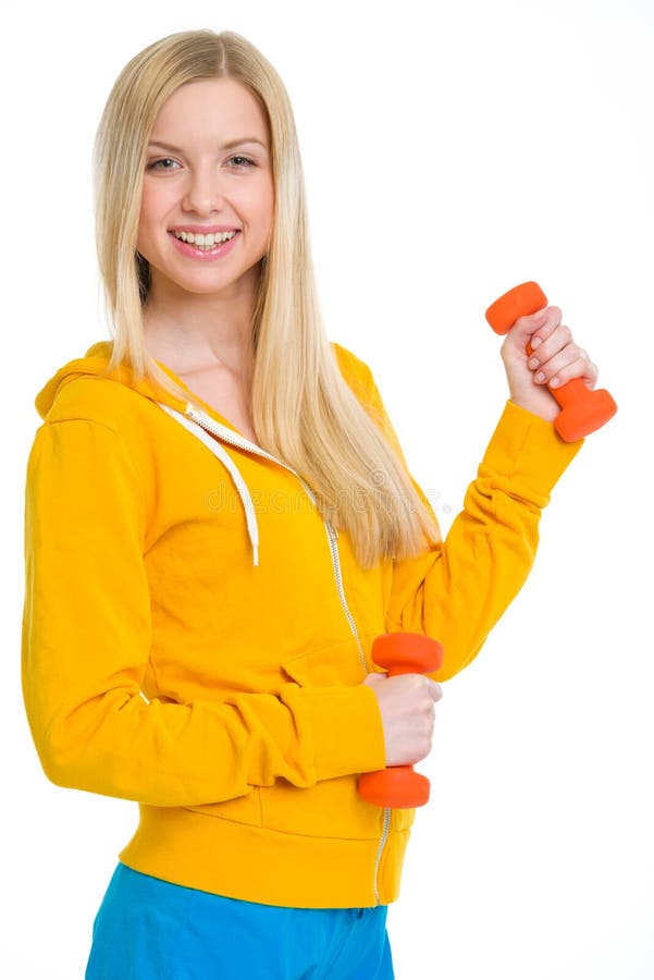 Muchacha feliz del adolescente con pesas de gimnasia imágenes de archivo libres de regalías Muchacha feliz del adolescente con pesas de gimnasia imágenes de archivo libres de regalías