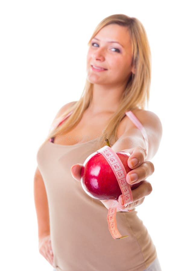 Muchacha grande del tamaño extra grande de la mujer con pérdida de peso de medición de la cinta de la manzana. Aislado. imágenes de archivo libres de regalías Muchacha grande del tamaño extra grande de la mujer con pérdida de peso de medición de la cinta de la manzana. Aislado. imágenes de archivo libres de regalías