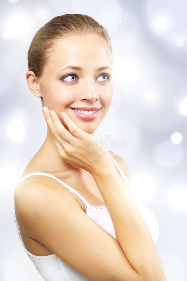 Beautiful girl with clean skin on a light background. Beautiful girl with clean skin on a light background