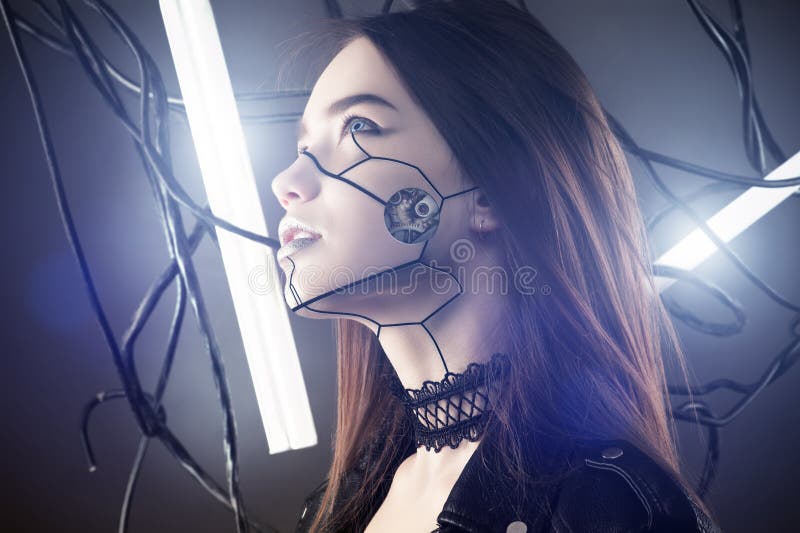 Beautiful robot girl in cyberpunk style looking up on background of wires and glowing lamps in studio shot. Beautiful robot girl in cyberpunk style looking up on background of wires and glowing lamps in studio shot