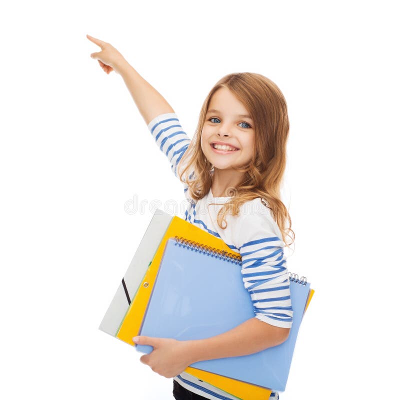 Education, school and virtual screen concept - cute little girl with colorful folders pointing in the air or virtual screen. Education, school and virtual screen concept - cute little girl with colorful folders pointing in the air or virtual screen