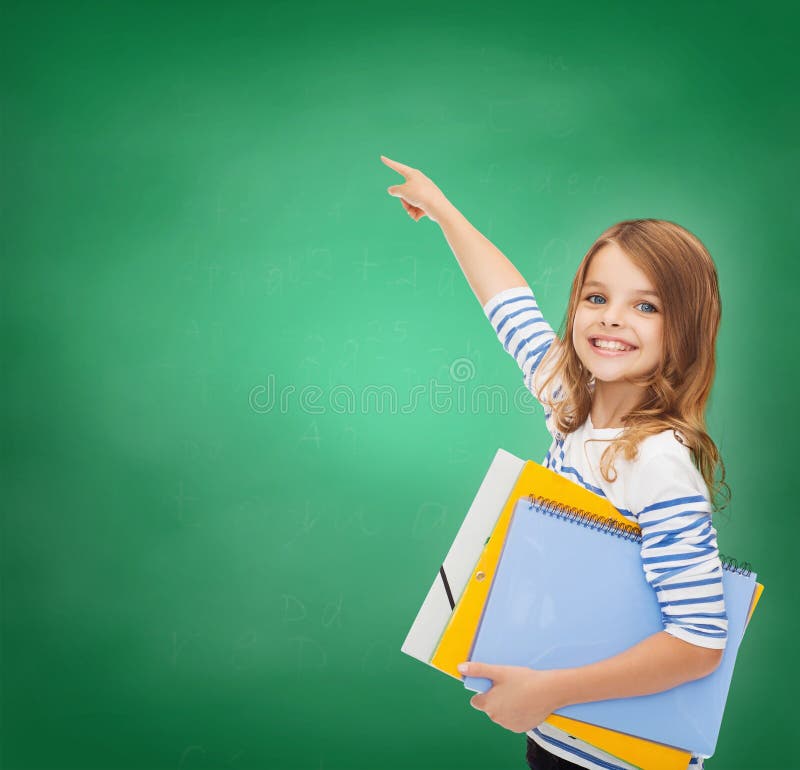 Education, school and virtual screen concept - cute little girl with colorful folders pointing in the air or virtual screen. Education, school and virtual screen concept - cute little girl with colorful folders pointing in the air or virtual screen